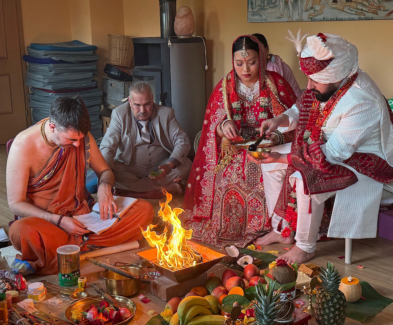 Bride and groom making the offering into the sacred fire during a Hindu wedding