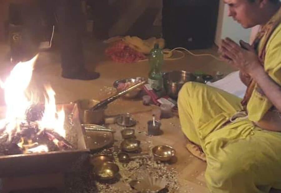 Vedic Homa with the sacred fire kindled and devotees gathered around it