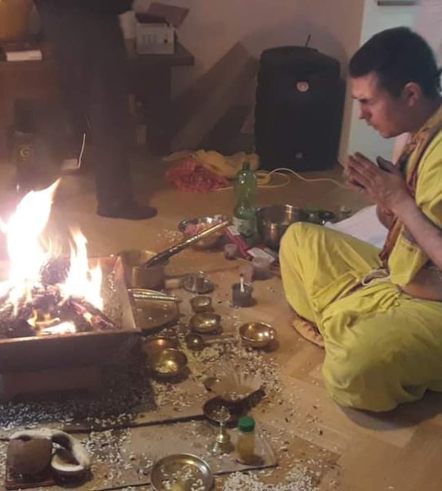 Vedic Homa with the sacred fire kindled and devotees gathered around it