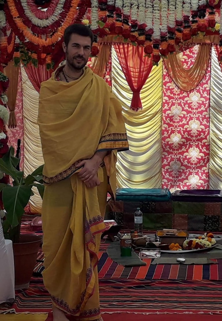 Pandit Sahadev standing in the mandap prepared for a Vedic ceremony